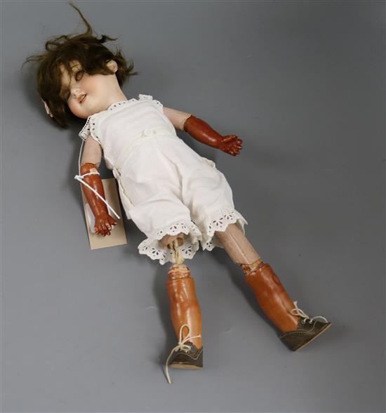 An Armand Marseille 390 open mouthed bisque headed doll, with overpainted body and a small collection of dolls clothes H.15in.
